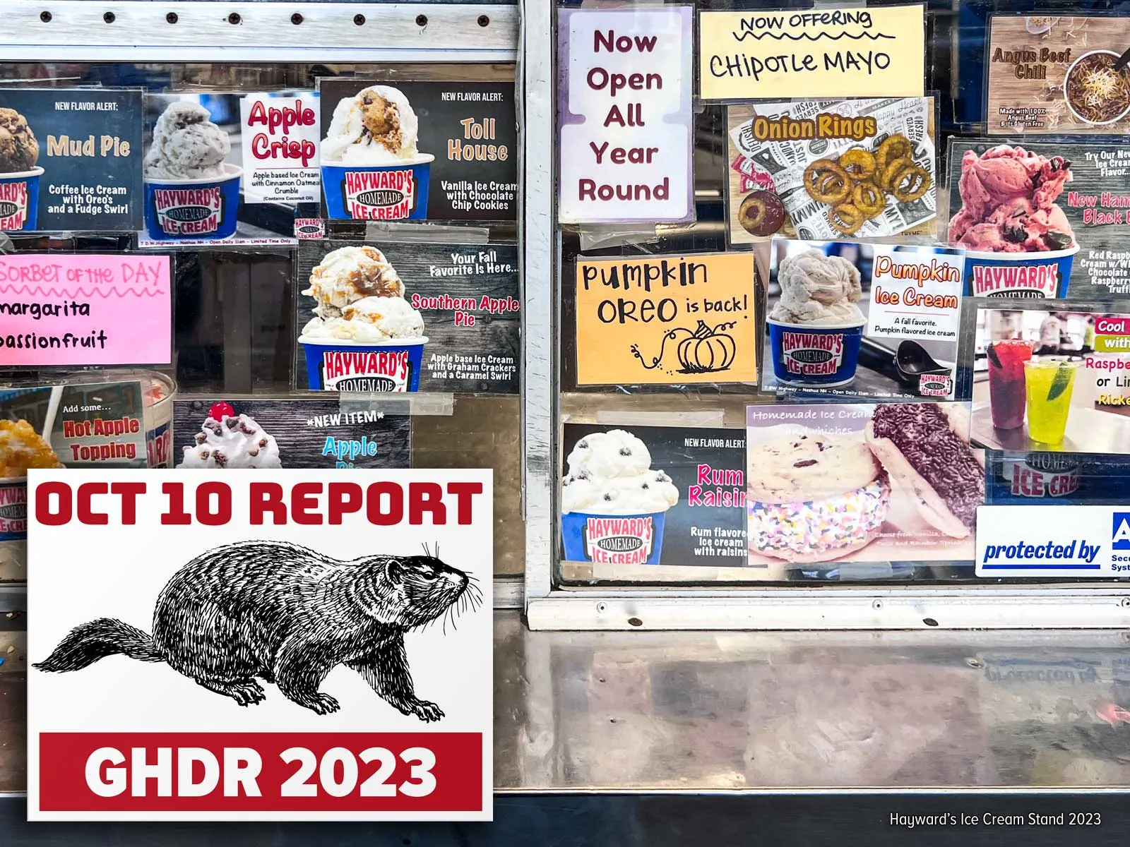 Photo of a New England ice cream stand order window showing many stickers for their food offerings (full size image)