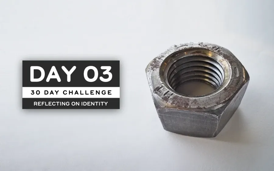 Picture of a large steel nut, scratched-up on a white background
