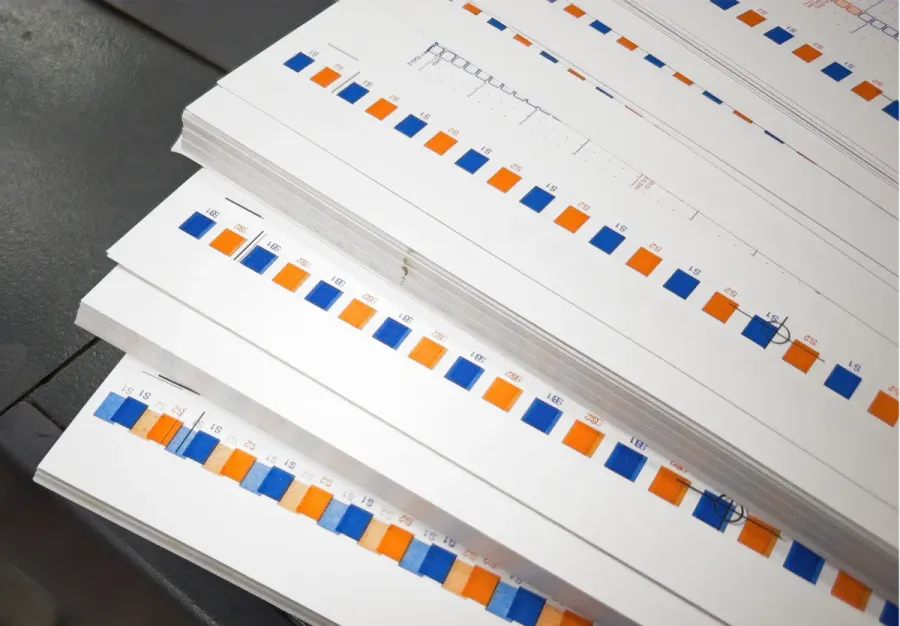 A stack of test prints, showing improving registration until they are sharply aligned.
