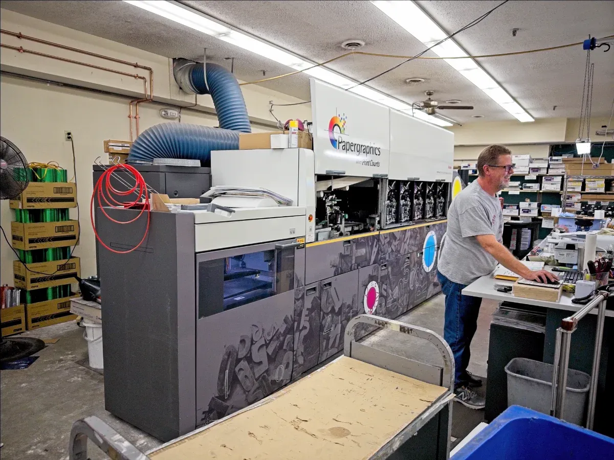 Papergraphic's Kodak Nexpress digital press with nearby operator (full size image)