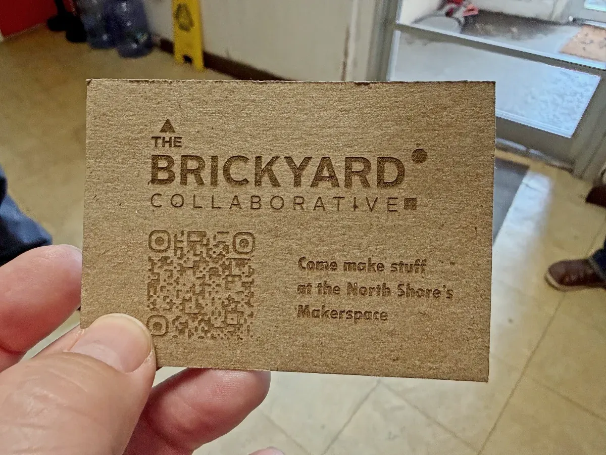 Business card made from unbleached cardboard for The Brickyard Collaborative, reading 'Come make stuff at the North Shore's Makerspace' (full size image)