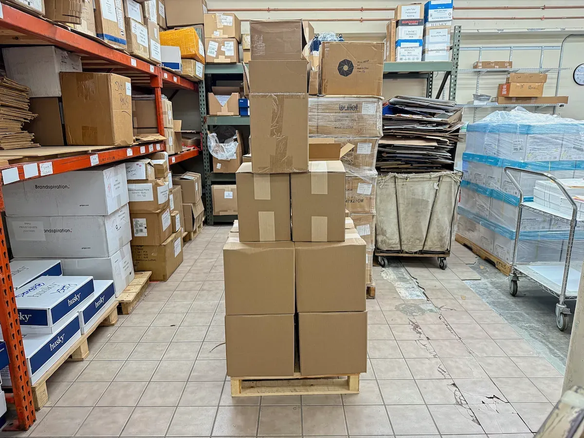 A pile of several medium-sized cardboard boxes packed Mini ETP Notebooks on the floor of the printing company that made them (full size image)