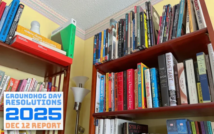 A bookshelf stocked with cookbooks, animation art, entrepreneurial, design, and scientific reference books