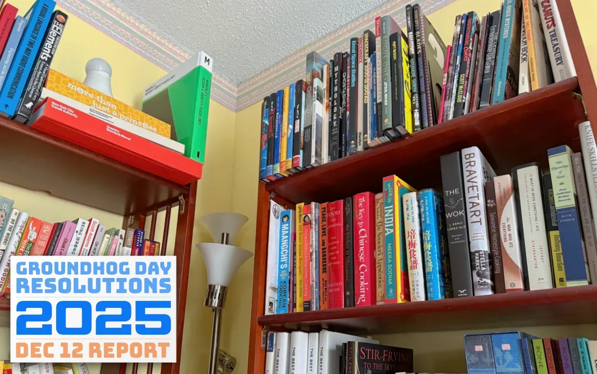 A bookshelf stocked with cookbooks, animation art, entrepreneurial, design, and scientific reference books (full size image)