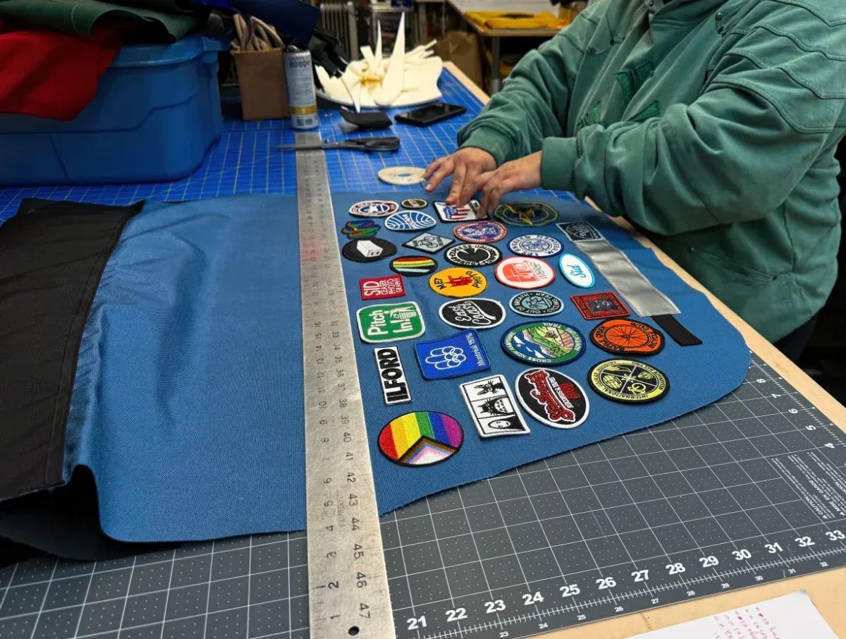 A messenger bag lid being customized with patches prior to final assembly (full size image)