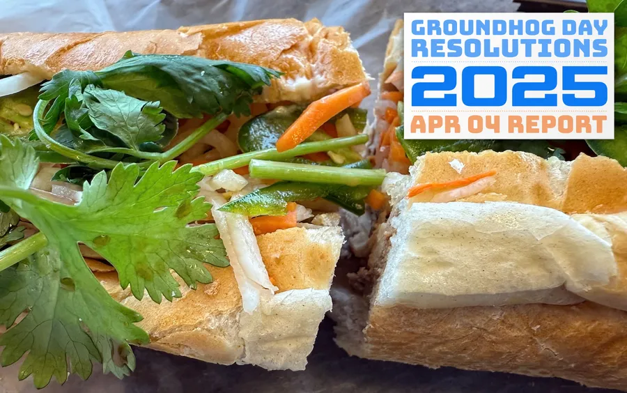 closeup of a Vietnamese banh-mi sandwich, loaded with vegetables and cold cuts in a baguette