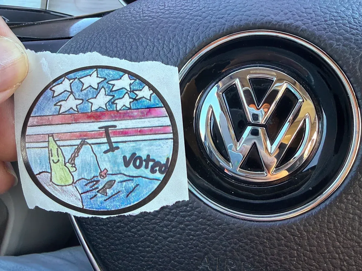 A small round sticker that says I VOTED on it, rendered in a children's drawing style (full size image)
