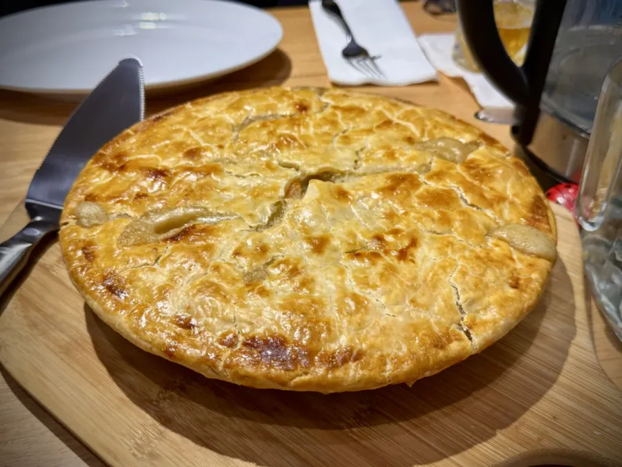 A freshly-baked chicken pot pie in a 9-inch pan