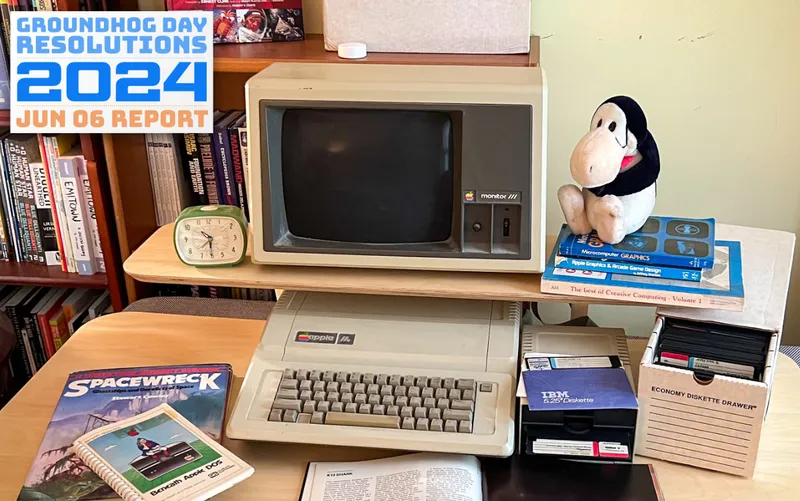Vintage Apple //e computer with spaceship books and programming manuals from the 1980s
