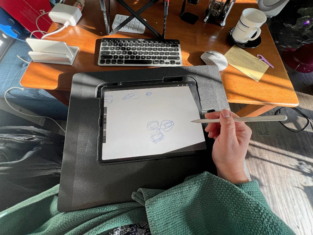 An iPad held in a drawing surface called The Darkboard, showing a drawing in Procreate. (full size image)