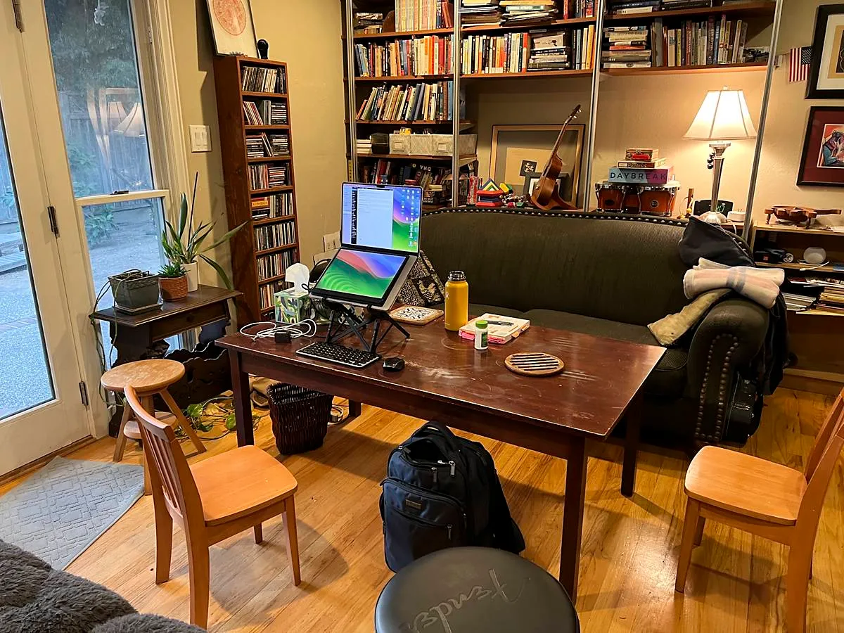 24-inch tall child's craft table with tiny chairs around it in a living room surrounded by bookshelves (full size image)